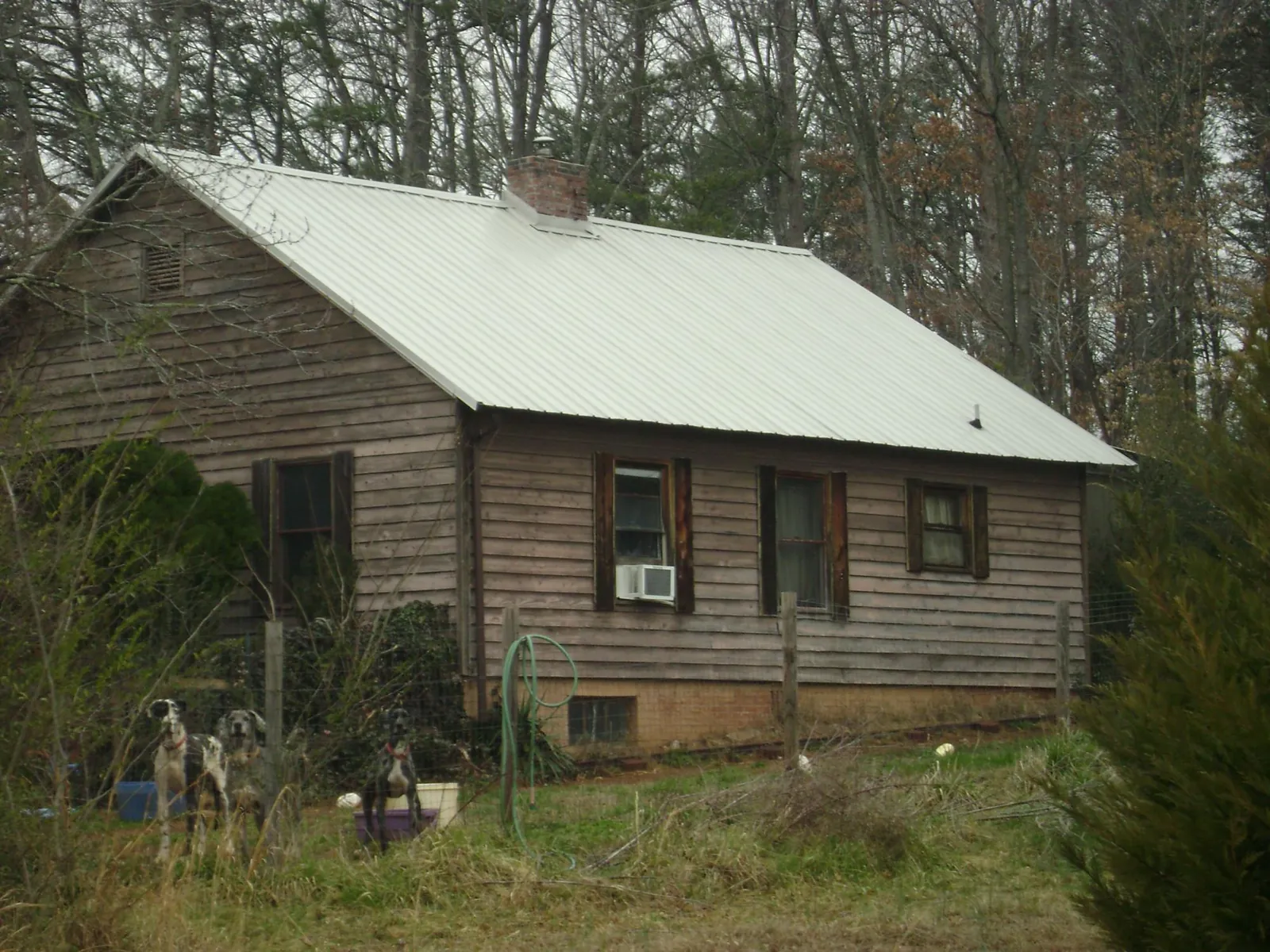White metal roof on an old wood sided farmhouse, from a Metal Roof Installation job in South Gardiner