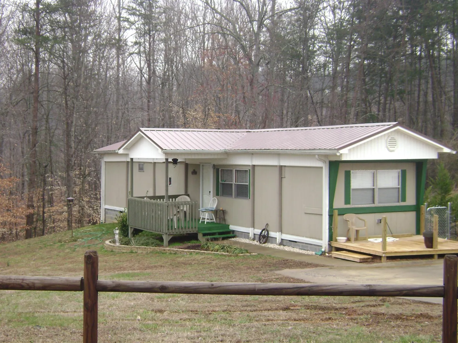 Mauve metal roof on a manufactured home with a new front deck in South Gardiner